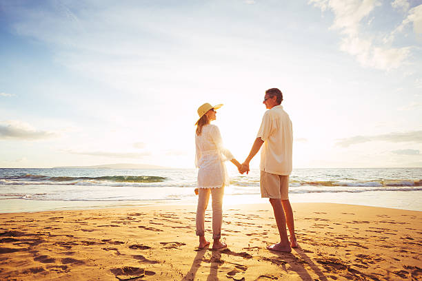 istock Mature Couple Walking on the Beach at Sunset 501640538