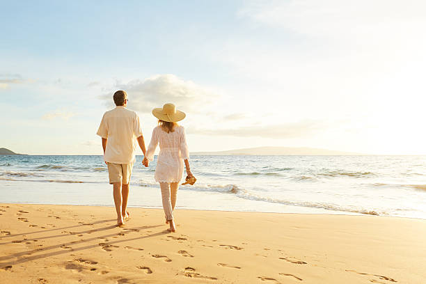 istock Mature Couple Walking on the Beach at Sunset 501640590