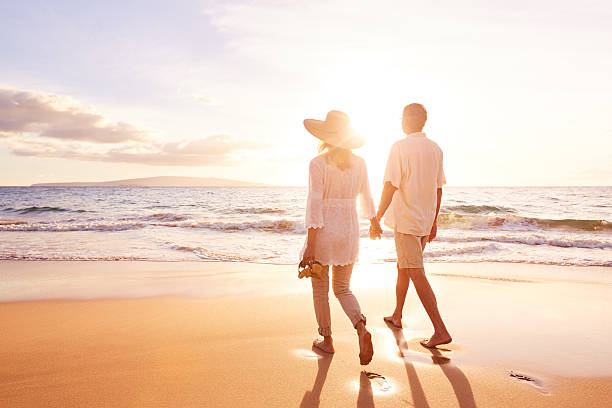 istock Mature Couple Walking on the Beach at Sunset 501640710