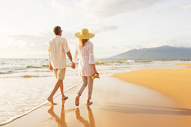 istock Mature Couple Walking on the Beach at Sunset 501640754
