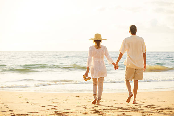 istock Mature Couple Walking on the Beach at Sunset 501640990