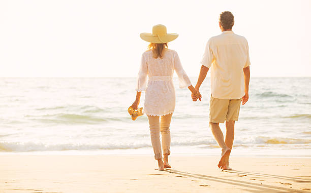 istock Mature Couple Walking on the Beach at Sunset 501641216