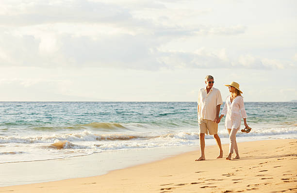 istock Mature Couple Walking on the Beach at Sunset 501641272