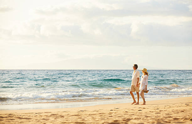 istock Mature Couple Walking on the Beach at Sunset 501641296