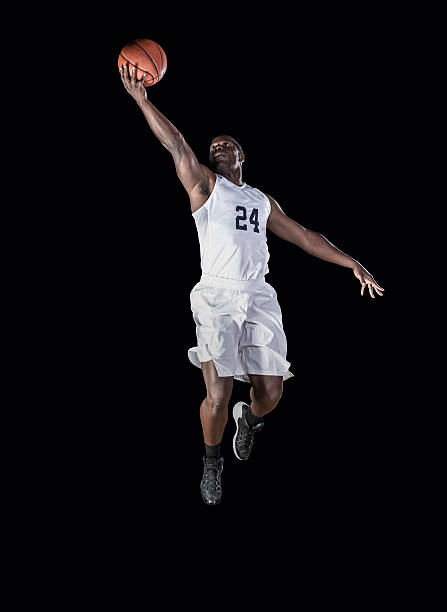 African American Basketball Player scoring a layup Athletic African american basketball player jumping high and scoring a layup. Shot on a Black Background basketball player photos stock pictures, royalty-free photos & images