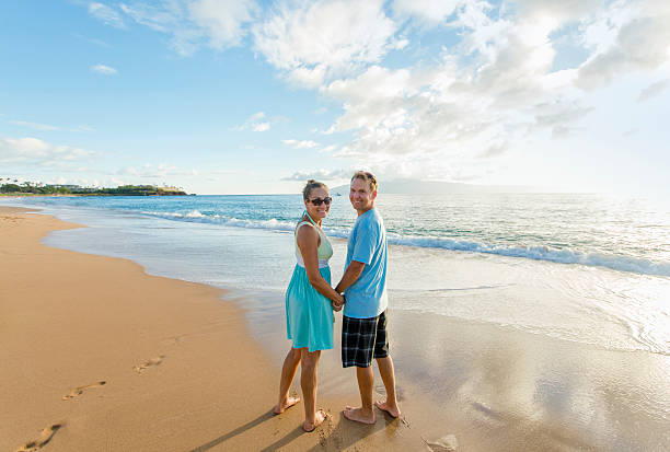 istock Couple in love walking along the beach together 501641812