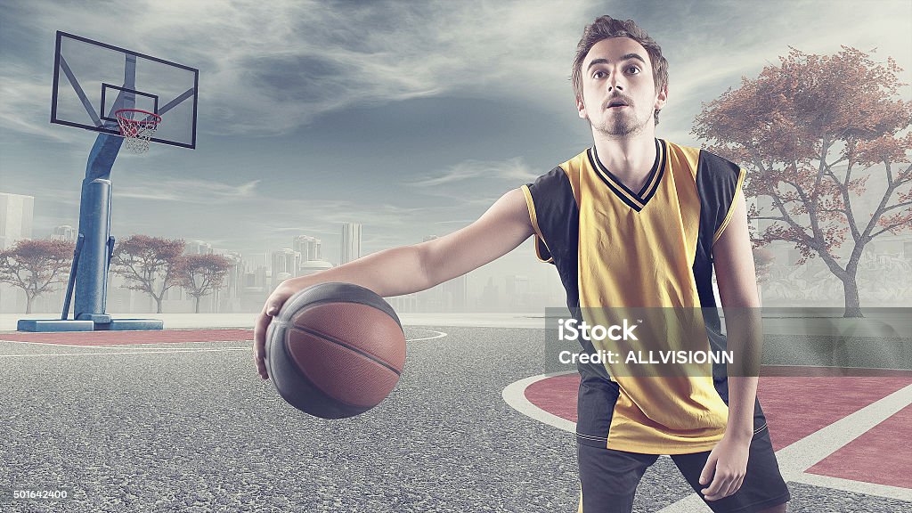 Young playing basketball Young playing basketball on a plot in the city 2015 Stock Photo