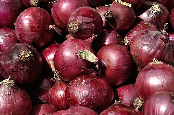 istock Red onions at a market stall 501643644