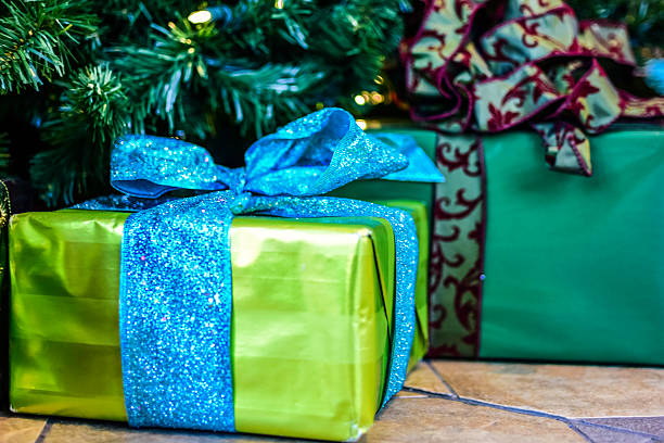 istock Gift in green wrapping paper and blue bow 501645276