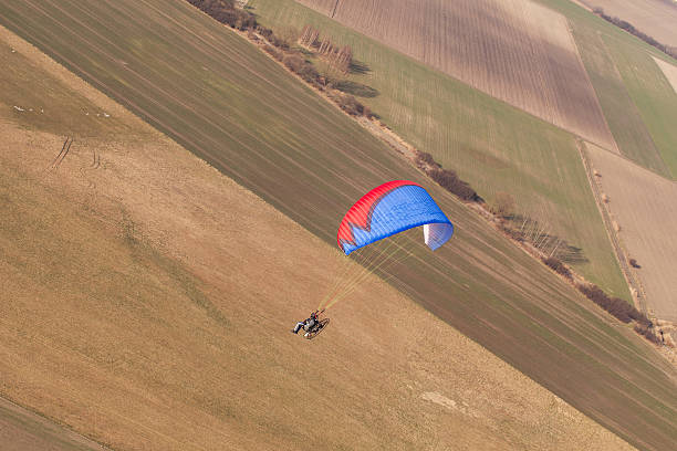 istock aerial view of paramotor flying over the harvest field 501645522