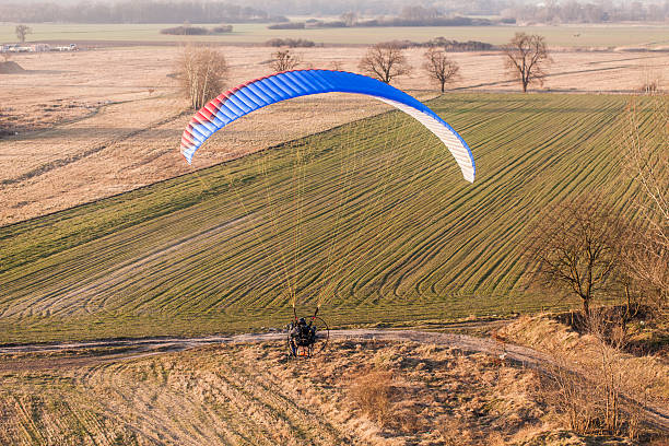 istock aerial view of paramotor flying over the harvest field 501645596