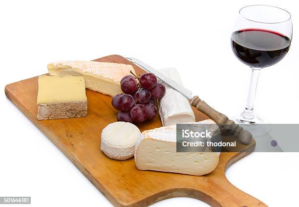 Composition Of Different Cheeses On A Wooden Cutting Board Stock Photo - Download Image Now