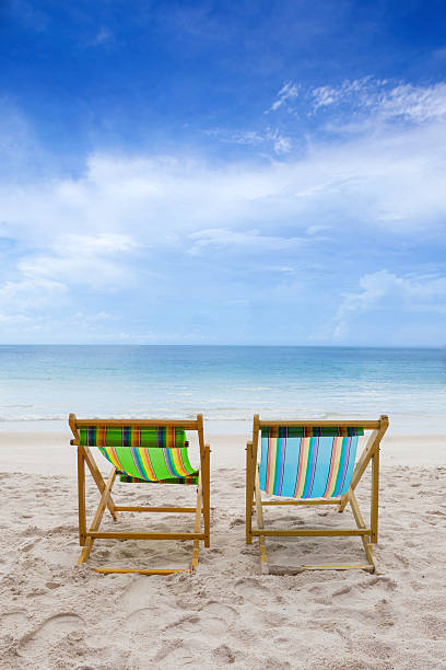 istock Beach chairs on the white sand  with cloudy blue sky 501646995