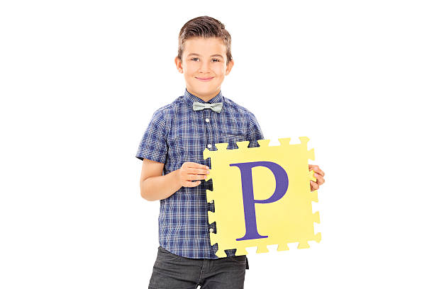 istock Male kid holding piece of a puzzle 501647637
