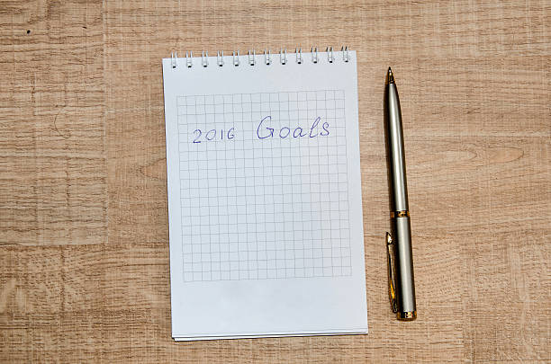 istock New year's resolutions written on notepad on wooden table 501648468