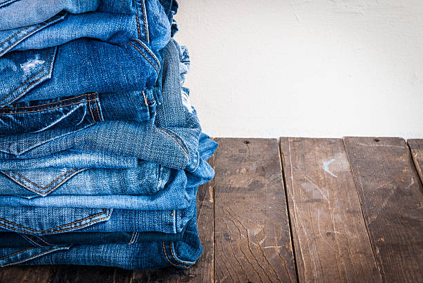istock stack of various shades of blue jeans on old wood 501648604