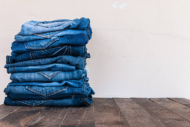 istock stack of various shades of blue jeans on old wood 501648824