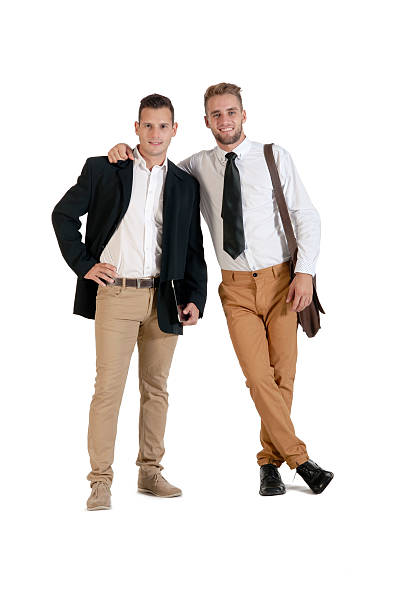Two young attractive businessmen working with digital tablet stock photo