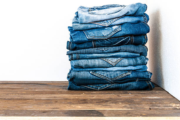 istock stack of various shades of blue jeans on old wood 501649126