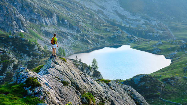 istock Girl looks mountain lake 501650026