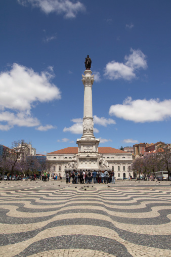 Lisbon, Portugal - May 27, 2014: A tour group visiting Rossio Square in old downtown Lisbon.  Rossio Square has been one of Lisbon´s main squares since the Middle Ages.