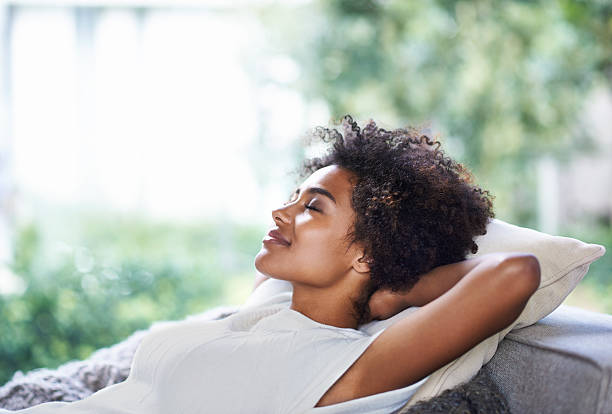 Taking in some me-time Shot of young woman relaxing at homehttp://195.154.178.81/DATA/i_collage/pi/shoots/783516.jpg resting stock pictures, royalty-free photos & images