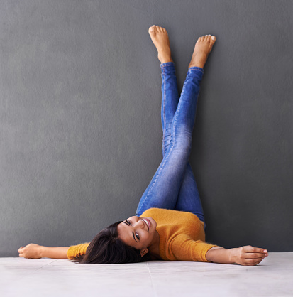 Shot of an attractive young woman lying on the floor with her feet against the wallhttp://195.154.178.81/DATA/i_collage/pi/shoots/783562.jpg