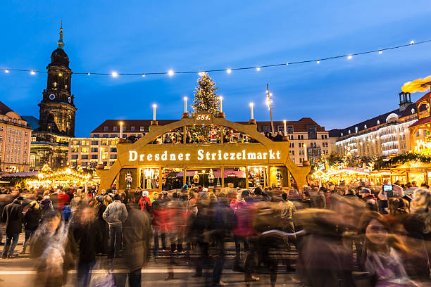 Dresden, Germany - December 12, 2015: People enjoy Christmas market in Dresden. It is Germany's oldest Christmas Market (called Striezelmarkt) with a very long history dating back to 1434. 