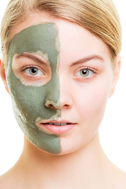 istock Woman in clay mud mask on face isolated on white. 501652688