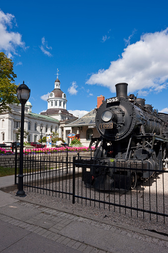 Kingston, Canada - September 24, 2009. Locomotive built in Kingston for the Canadian Pacific Railway in 1913. City Hall in the background. Kingston is one of the best architectural history destinations in Canada. Clear autumn light shines through the downtown streets. Picture taken with tilt and shift lenses.