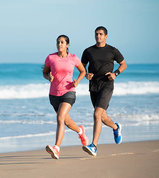 Couple running at summer seaside. stock photo