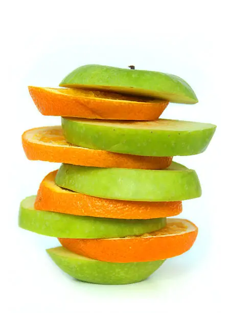 Photo showing a piece of fruit reformed from piling alternating slices of a green, Granny Smith apple (Malus 'Granny Smith') and Naval orange (Citrus).