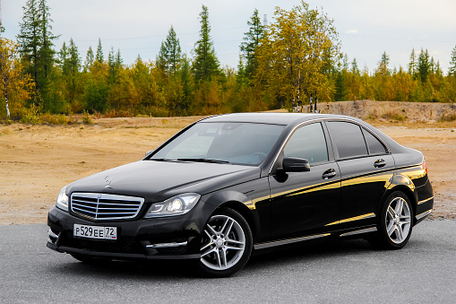 Novyy Urengoy, Russia - August 30, 2015: Motor car Mercedes-Benz W204 C-class is parked at the countryside.