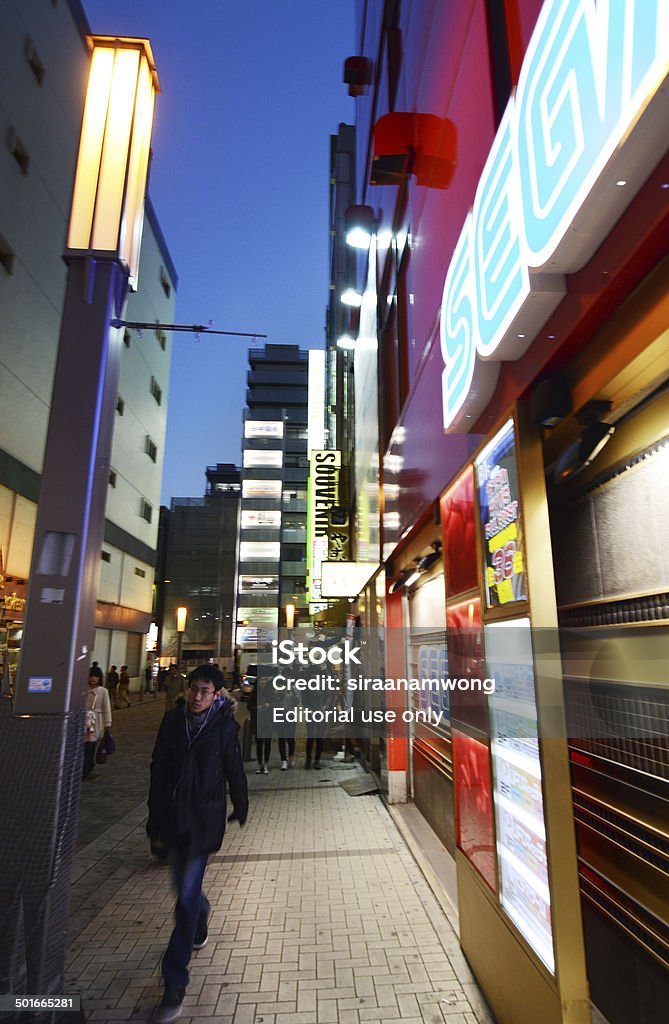 Tokyo, Japan - November 21, 2013: People visit  Akihabara district Tokyo, Japan - November 21, 2013: People visit Akihabara district November 21, 2013 in Tokyo, Japan. The district is a major shopping area for electronic, computer, anime, games and otaku goods. Adulation Stock Photo