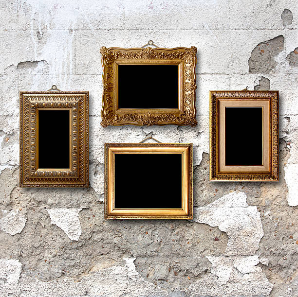 istock Gilded wooden frames for pictures on old stone wall 501665565
