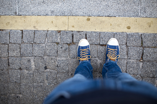 Feet and shoes. Selfie image taken from above.