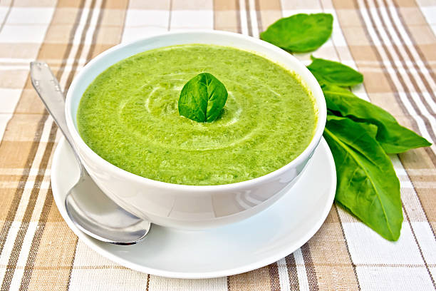 istock Soup puree with spinach and spoon in bowl on fabric 501667193