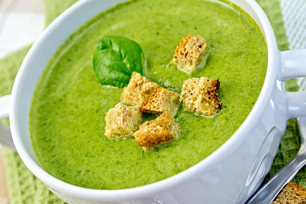 istock Soup puree with spinach leaves and croutons on napkin 501667195