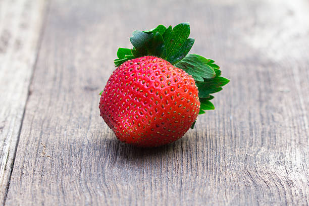 istock red strawberries on an old wooden textured table 501667365