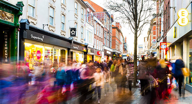 Shoppers hurry past in post-Christmas sales frenzy 2013. View along Clumber Street (toward Victoria Shopping Centre), Nottingham, England. 28th Dec 2013, busy post-Christmas sales. Captured with a long shutter speed to produce creative blur, and render faces blurred. nottingham stock pictures, royalty-free photos & images