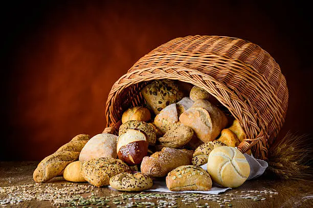 bun basket on a wooden traditional table in still-life setup