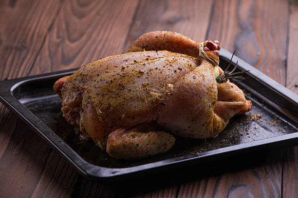 istock Raw whole chicken with salt and pepper 501668612