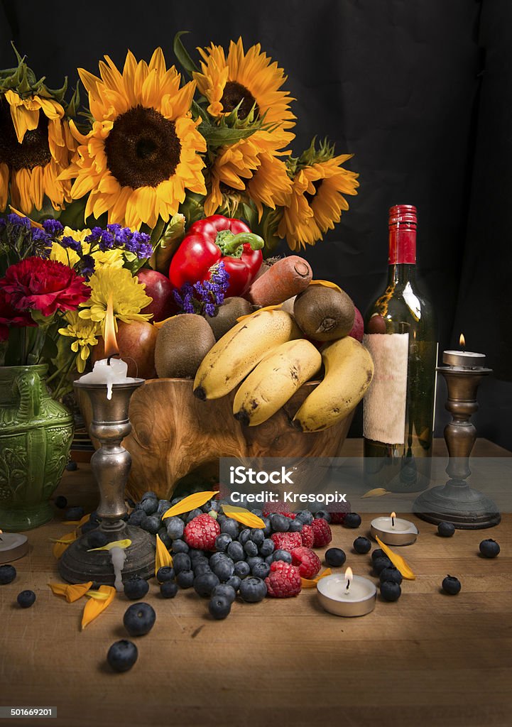 Cornucopia Vancouver, Canada - July, 09. 2014 - Still life of Cornucopia full of fresh fruits and veggies with wine, on a rich warm background, vertical view Abundance Stock Photo