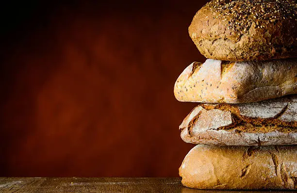 pile of bread  on a wooden table with free space