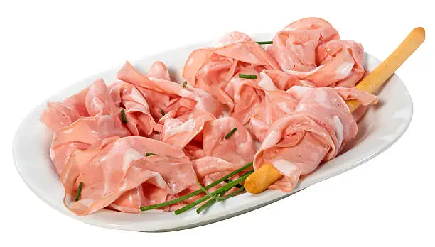 Mortadella slices on a plate,isolated on white with clipping path.