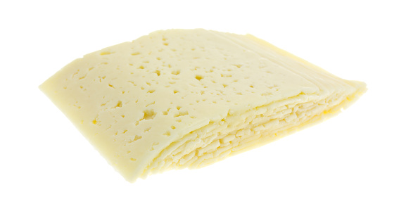 A stack of sliced Havarti cheese isolated on a white background.