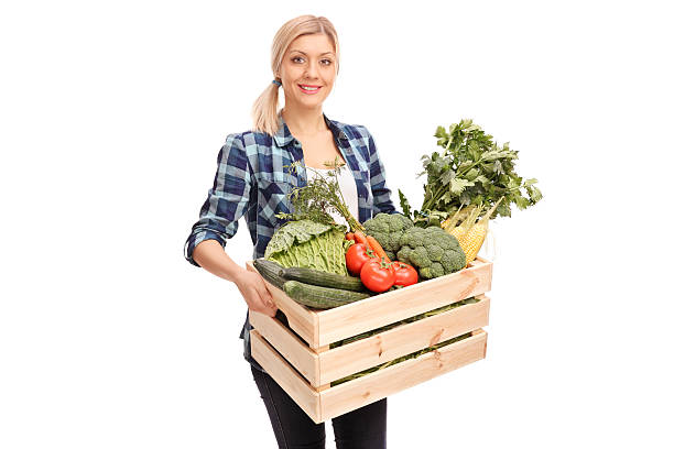 istock Female farmer carrying a crate with vegetables 501670550
