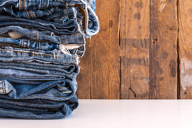 istock stack of various shades of blue jeans on old wood 501671046