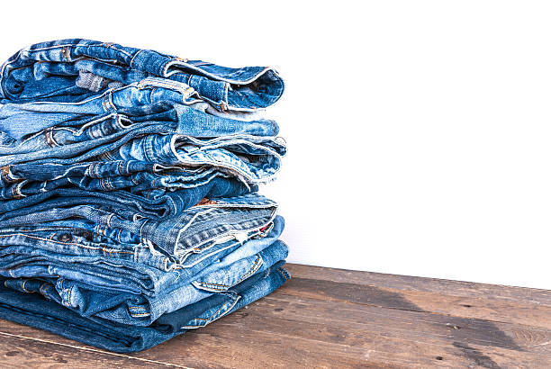istock stack of various shades of blue jeans on old wood 501671358