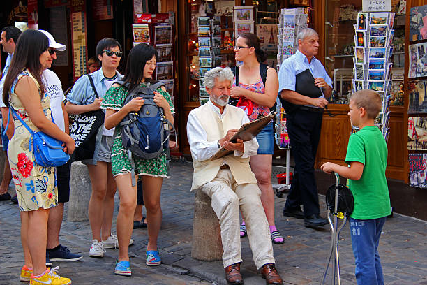 Paris, France - July 23, 2015: A street artist working on a portrait of a tourist in the Place du Tertre in Montmartre, the famous artist colony that was once the home of such famed painters as Picasso and Utrillo.